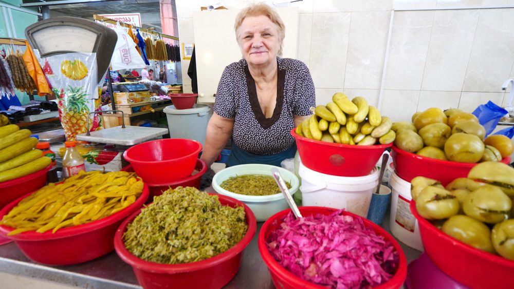 A woman selling pickled vegetables at Green Bazaar in Kutaisi, Georgia