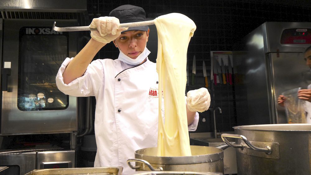 A cook preparing sulguni cheese at Rigi Restaurant