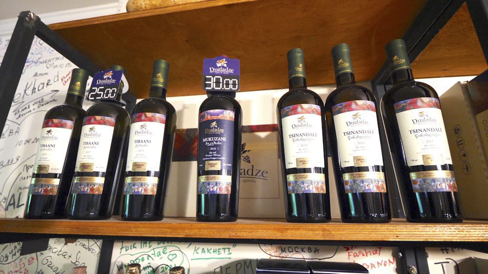 Bottles of wine on a shelf at Vineria Kakheti