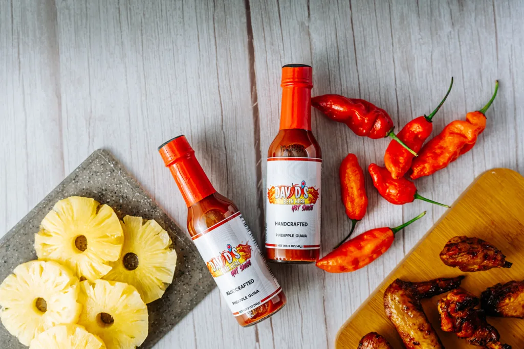 Two bottles of the best hot sauce, David's Been Here Hot Sauce, with chicken, chilies, and pineapple | Davidsbeenhere
