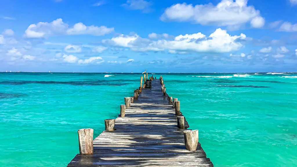 A wooden dock extending into the Caribbean Sea at Punta Cancun, Mexico | Davidsbeenhere