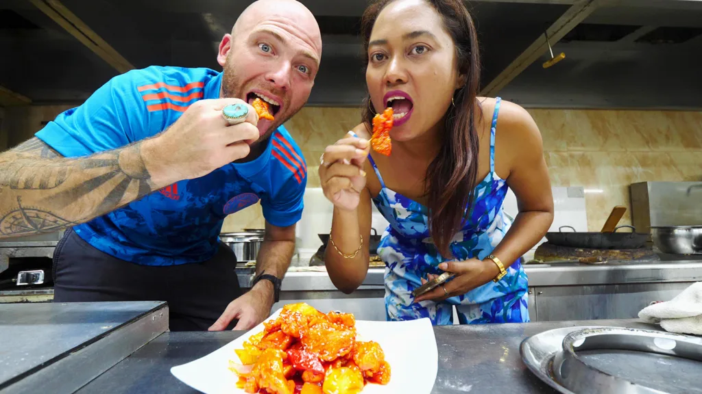 David Hoffmann and his guide Stacy enjoy sweet and sour chicken in the kitchen of New Thriving Restaurant | Davidsbeenhere