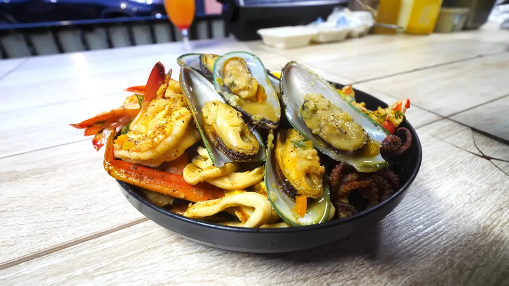 The Kaieteur Falls Platter at Fireside Grill n Chill in Georgetown, Guyana, containing red snapper, scallops, crab legs, lobster, prawns, calamari, octopus, and corn | Davidsbeenhere