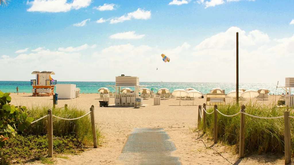 A view of umbrellas and a lifeguard stand on the sands of Miami Beach | Davidsbeenhere