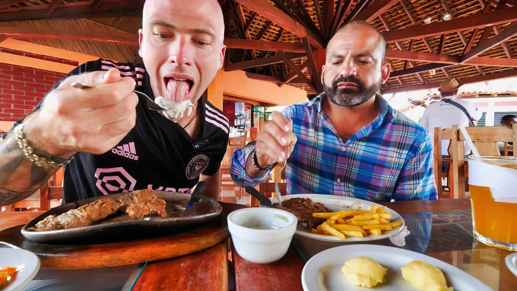 David Hoffmann and his guide Carlos eating steak at a restaurant in Managua, Nicaragua | Davidsbeenhere