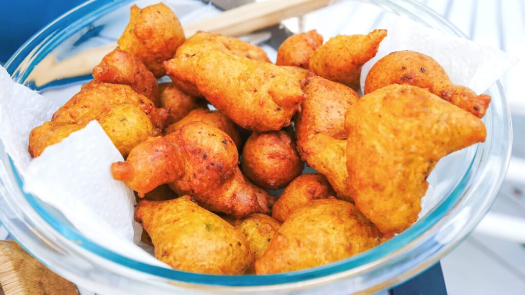A glass bowl full of freshly fried split pea fritters called pholourie | Davidsbeenhere